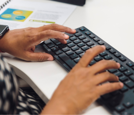 student typing on keyboard