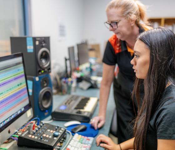 Lecturer and Student using computer for sound